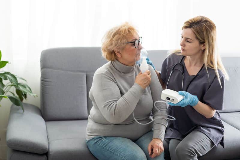 Respiratory therapist giving patient a breathing treatment